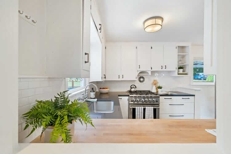 white kitchen with light wooden benchtop
