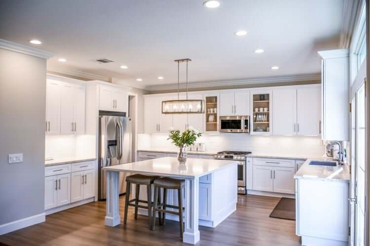 White kitchen with wooden floor and lots of light